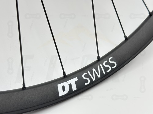 Czarne koło Dt Swiss FR571 z piastą tanke th490 w rozmiarze 27,5 z czarnymi szprychami dt swiss champion. Zbliżenie na biały napis dt swiss