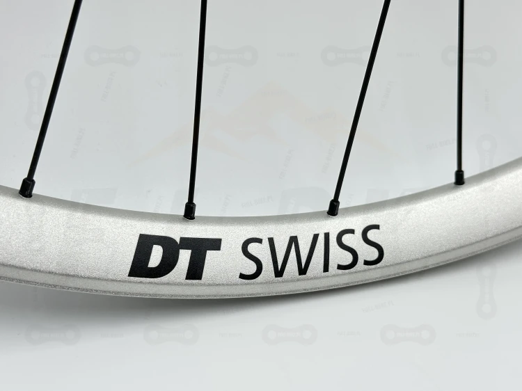 Zbliżenie na srebrną obręcz DT Swiss Fr571 29" i czarny napis Dt swiss