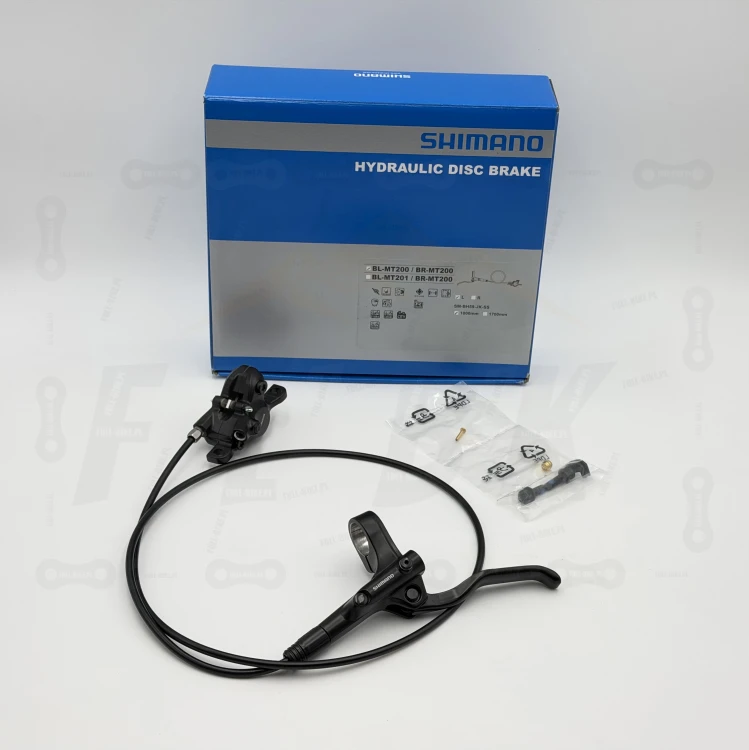 Hamulec tarczowy Shimano Mt-200, na zdjęciu jest przedni hamulec wraz ze śrubami mocującymi zacisk oraz opakowanie producenta gdzie widnieją wszystkie informacje o produkcie
