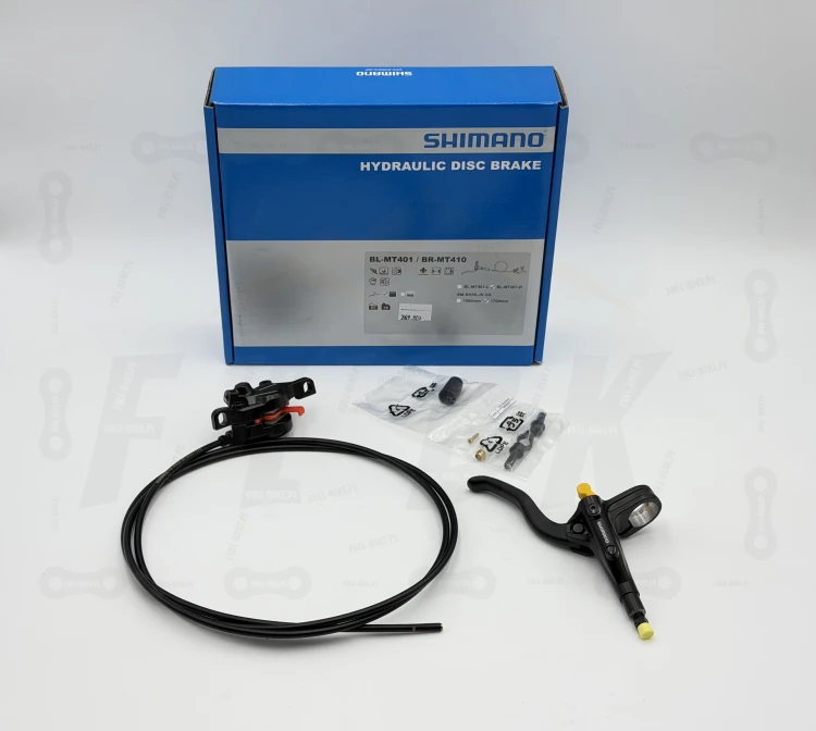 Hamulec tarczowy Shimano Mt-401/410 na zdjęciu widać tylni hamulec wraz z niezbędnymi cześciami takie jak śruby mocujące oraz opakowanie producenta ze wszystkimi informacjami o produkcie